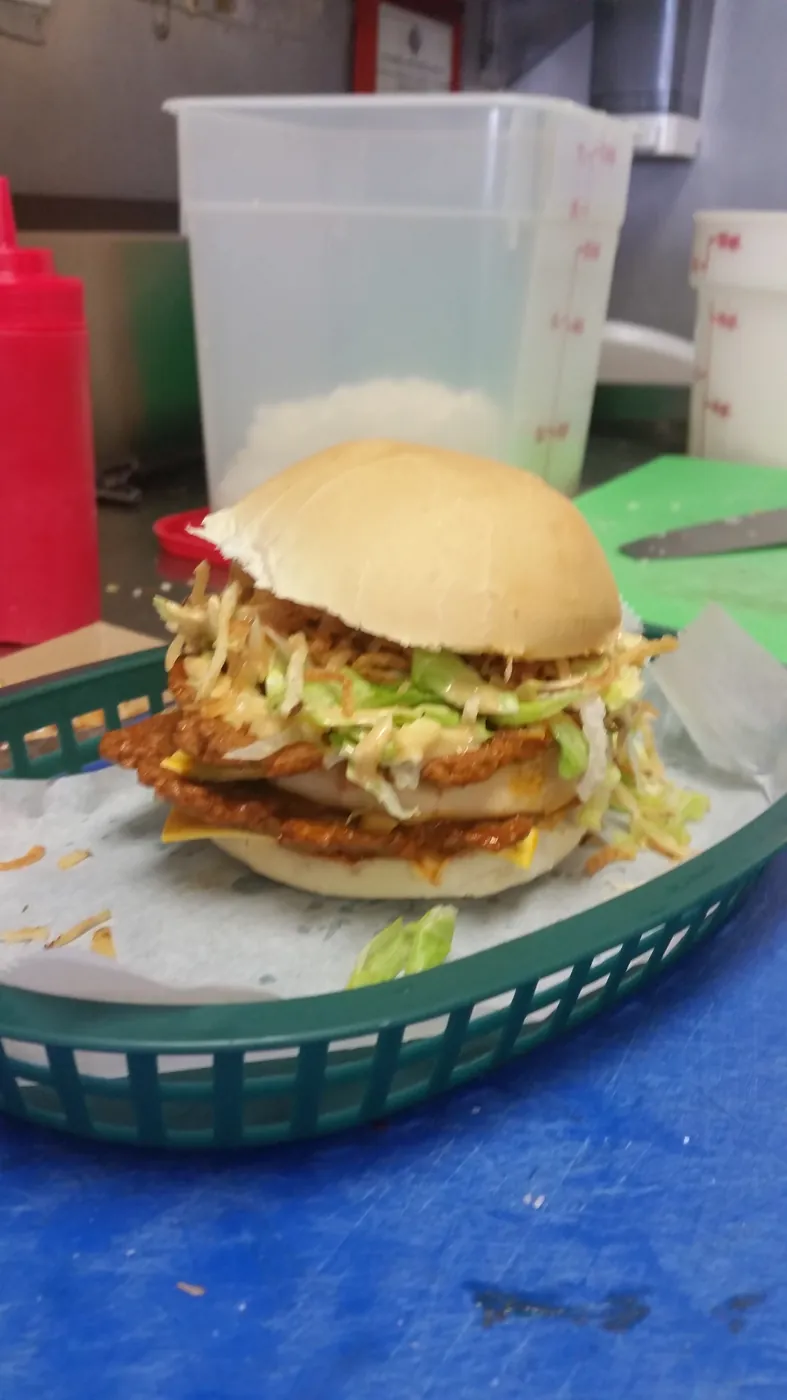 Cuban frita burger with shoestring potatoes served in a basket